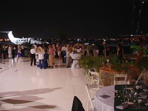Guests socialized and bid in the hangar with the doors to the runway opened behind them.
